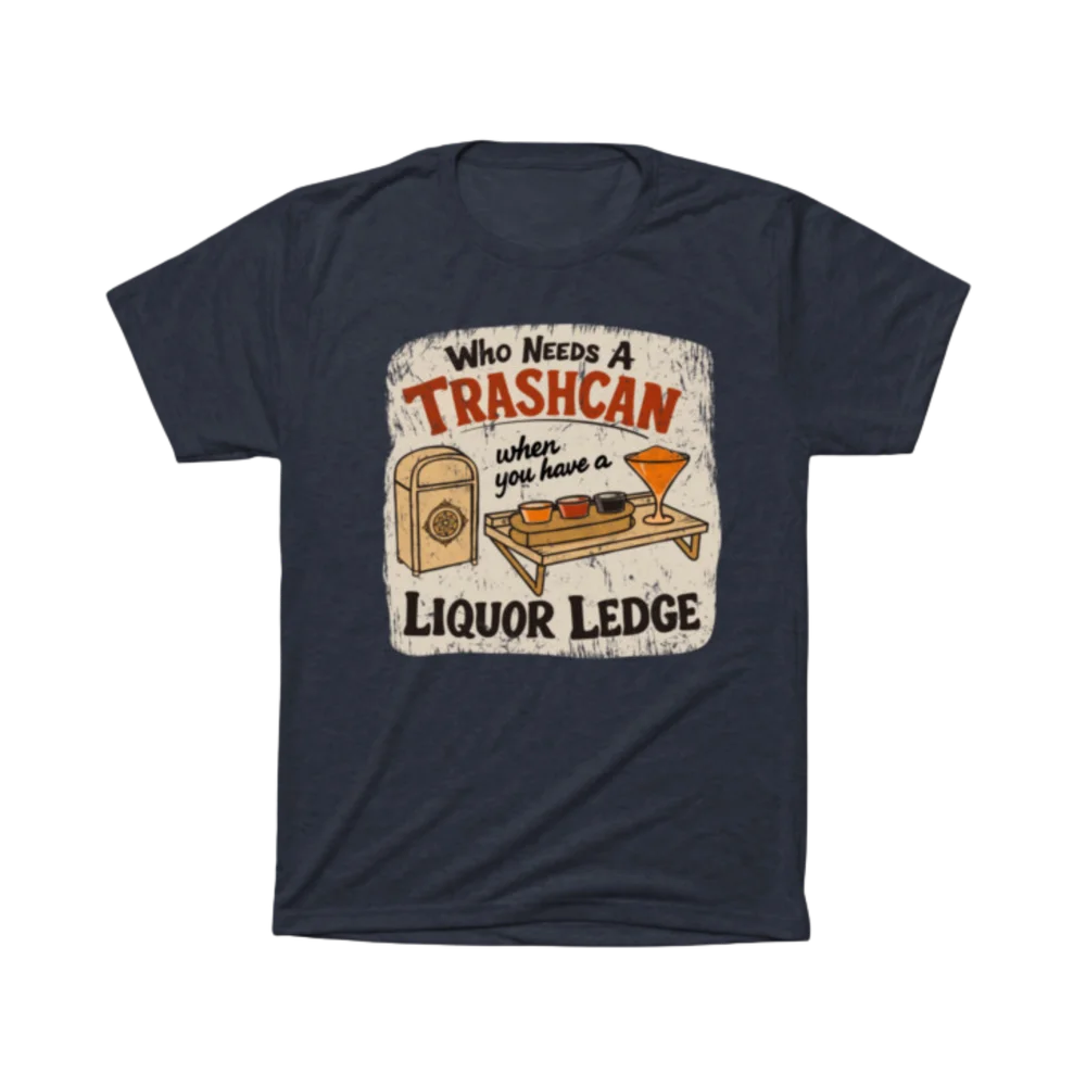 Navy blue t-shirt printed with the Liquor Ledge design — "Who Needs a Trashcan When You Have a Liquor Ledge," a theme-park trash can beside a mini flight-tasting tray with three dips and a frozen cocktail.