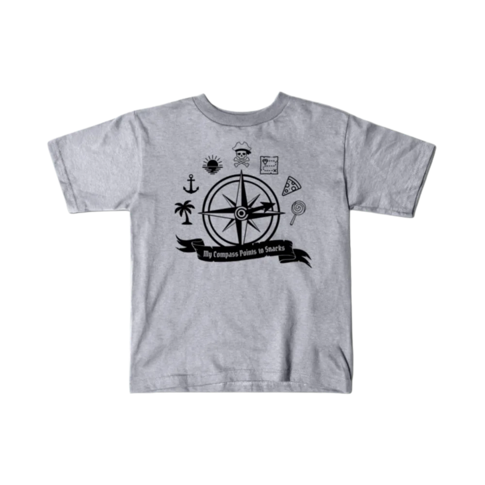 Heather gray kids t-shirt printed with the My Compass Points to Snacks design in black ink — a pirate-style compass rose surrounded by a skull and crossbones, treasure map, palm tree, pizza slice, and lollipop.